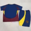 AS Roma 2024/25 Third Kit for kids featuring a dark blue base with deep red and yellow accents. The yellow ASR monogram in a red circle represents Roma's historic identity. The jersey numbers feature a 'sampietrini' pattern, inspired by Testaccio’s street pavements. Dark blue shorts and socks complete the kit, with yellow and red details.