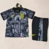Brazil Christ the Redeemer kids' shirt in black with center pattern, yellow logos, and Brazilian flag near the crest.