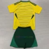 Celtic Away Kit Kids 2024/25 featuring a yellow base, green pinstripes, and a simplified club badge.