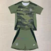 Celtic 24-25 kids' third kit featuring military green, camo graphics, and silver detailing.
