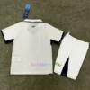 Napoli Away Kit Kids 202425 in white with black accents, featuring a 3D SSC Napoli badge, all-over "N" pattern, and special fingerprint hologram crest at the bottom.