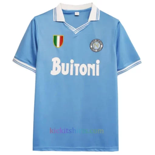The front of the Napoli Home Shirt 1986/87, featuring a light blue base, white collar and sleeve trims, Napoli crest, sponsor logo, and brand’s logo on the chest.