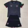 West Ham United Away Kit Kids 2024/25 featuring a black base with Claret trim, graphic of St Mary-le-Bow, and Bow Bells motif on the neck.